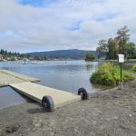 lakeside beach with wooden dock