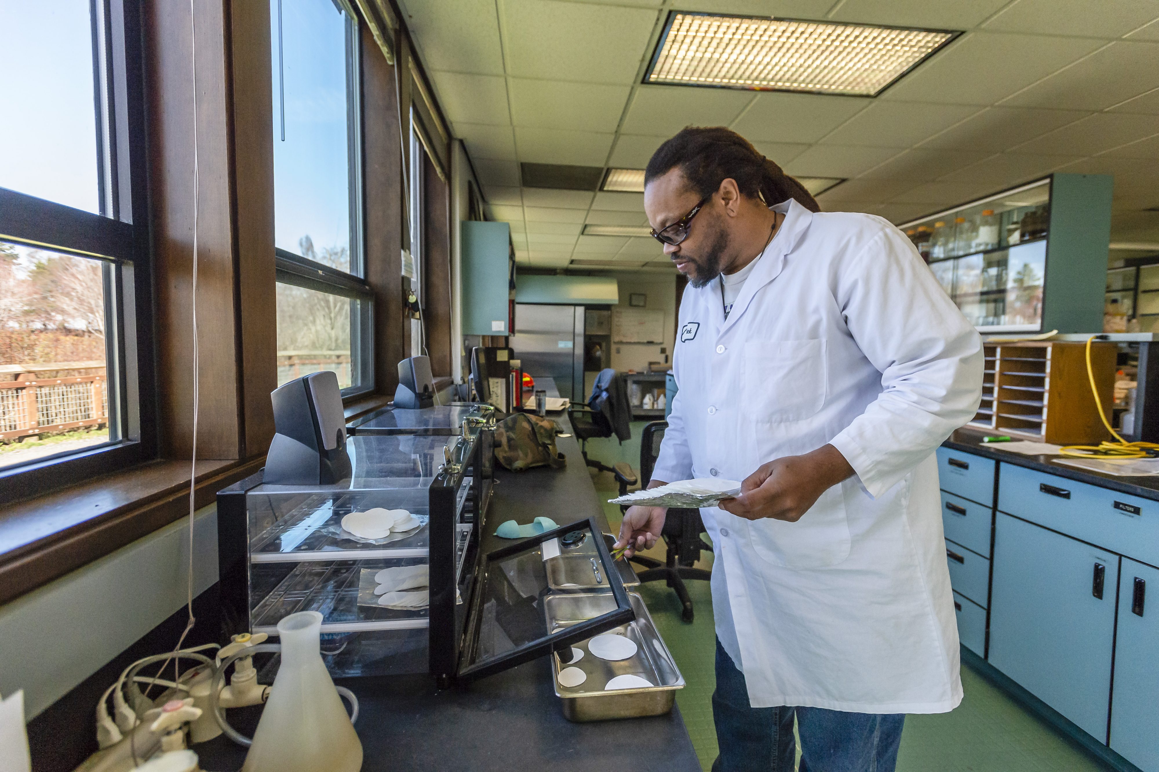 Man in lab coat in water treatment lab