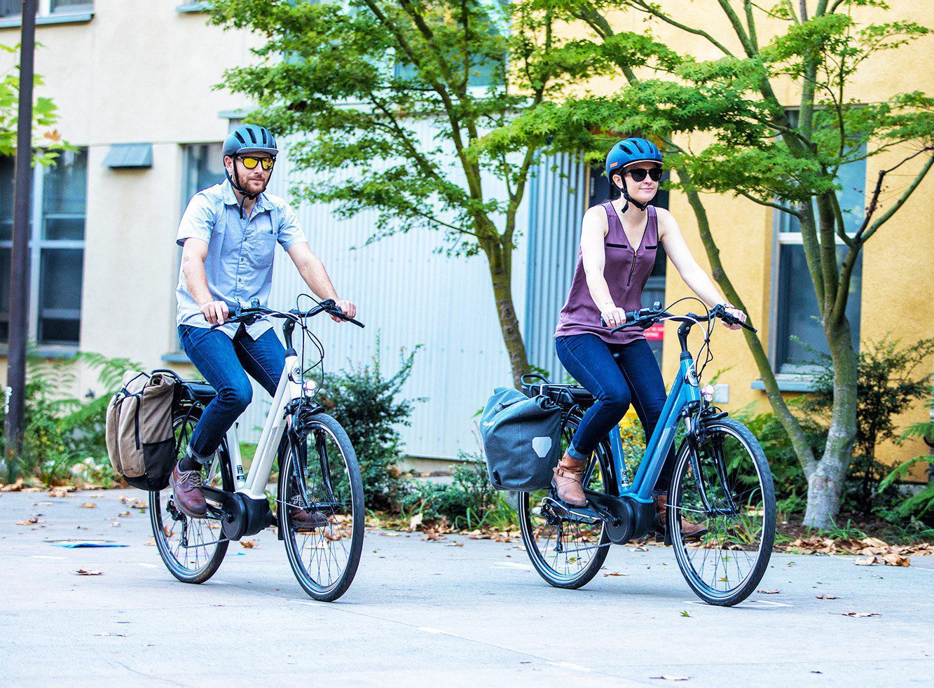 Two people riding electric bikes