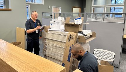 Two people working near a counter in the new finance department