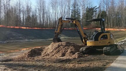 Excavator moving mulch