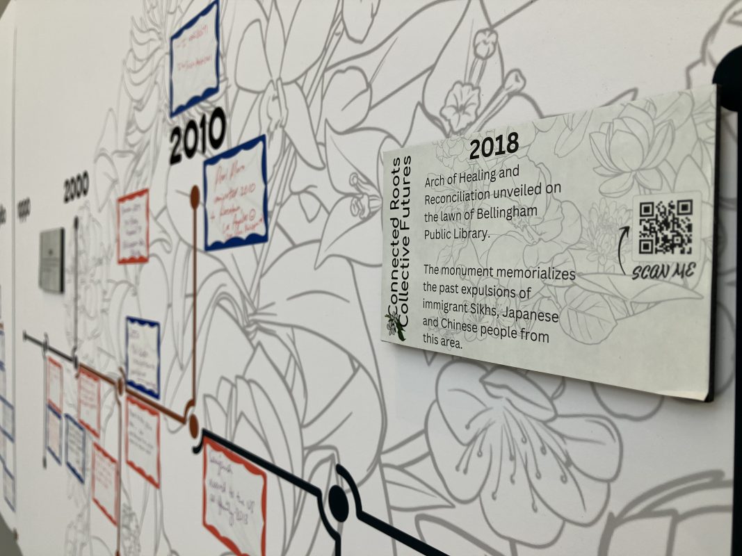 A close up view of the APIDA timeline with a 2018 entry about the Arch of Healing and Reconciliation at the corner of Lottie and Commercial Streets.