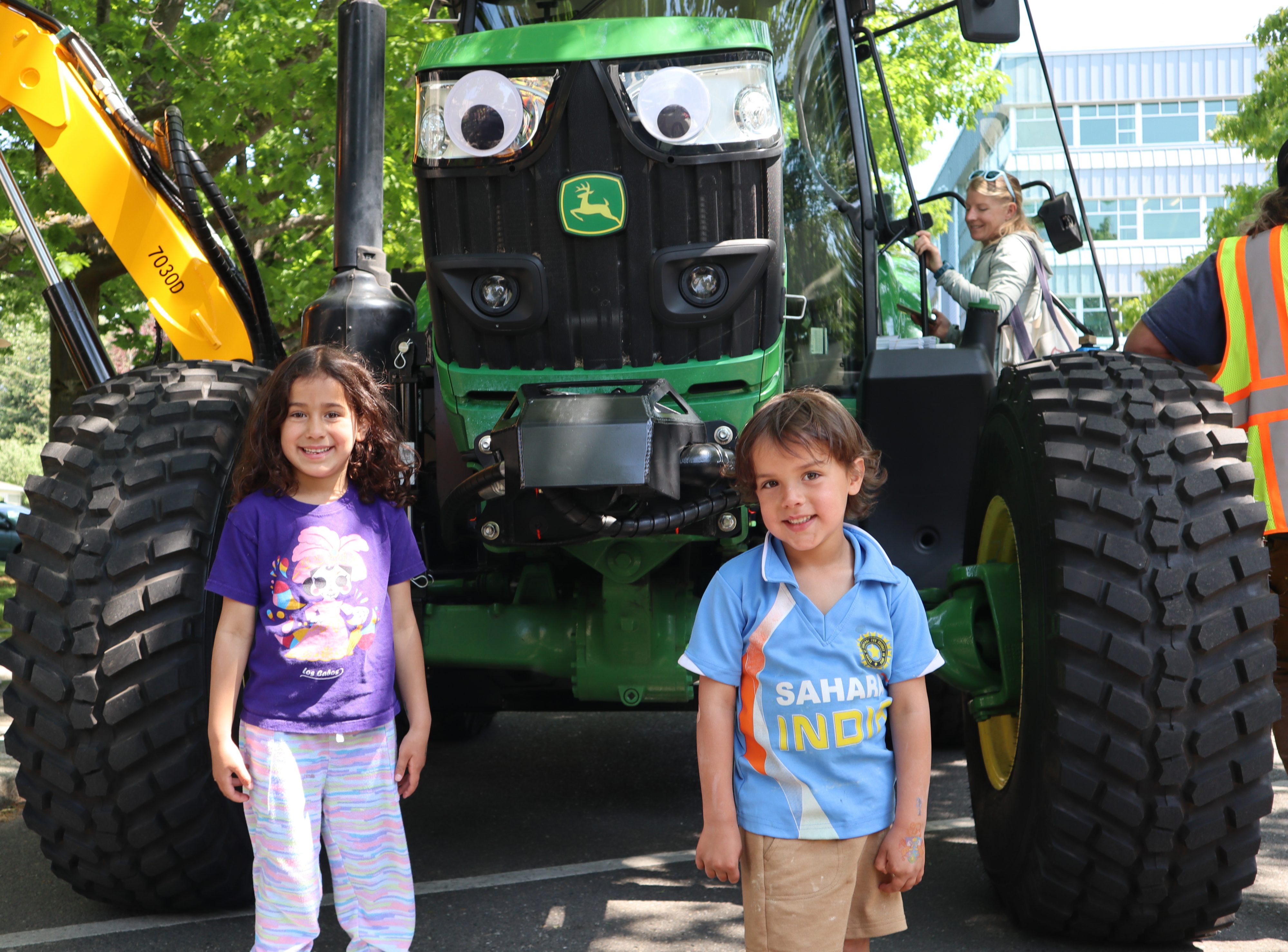 Two kids in front of tractor