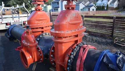 Large red valves on large water pipes 