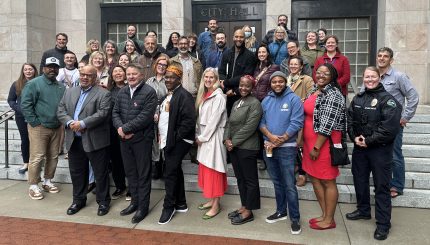 City and community leaders gather on the steps of City Hall for the 2024 Juneteenth flag-raising ceremony