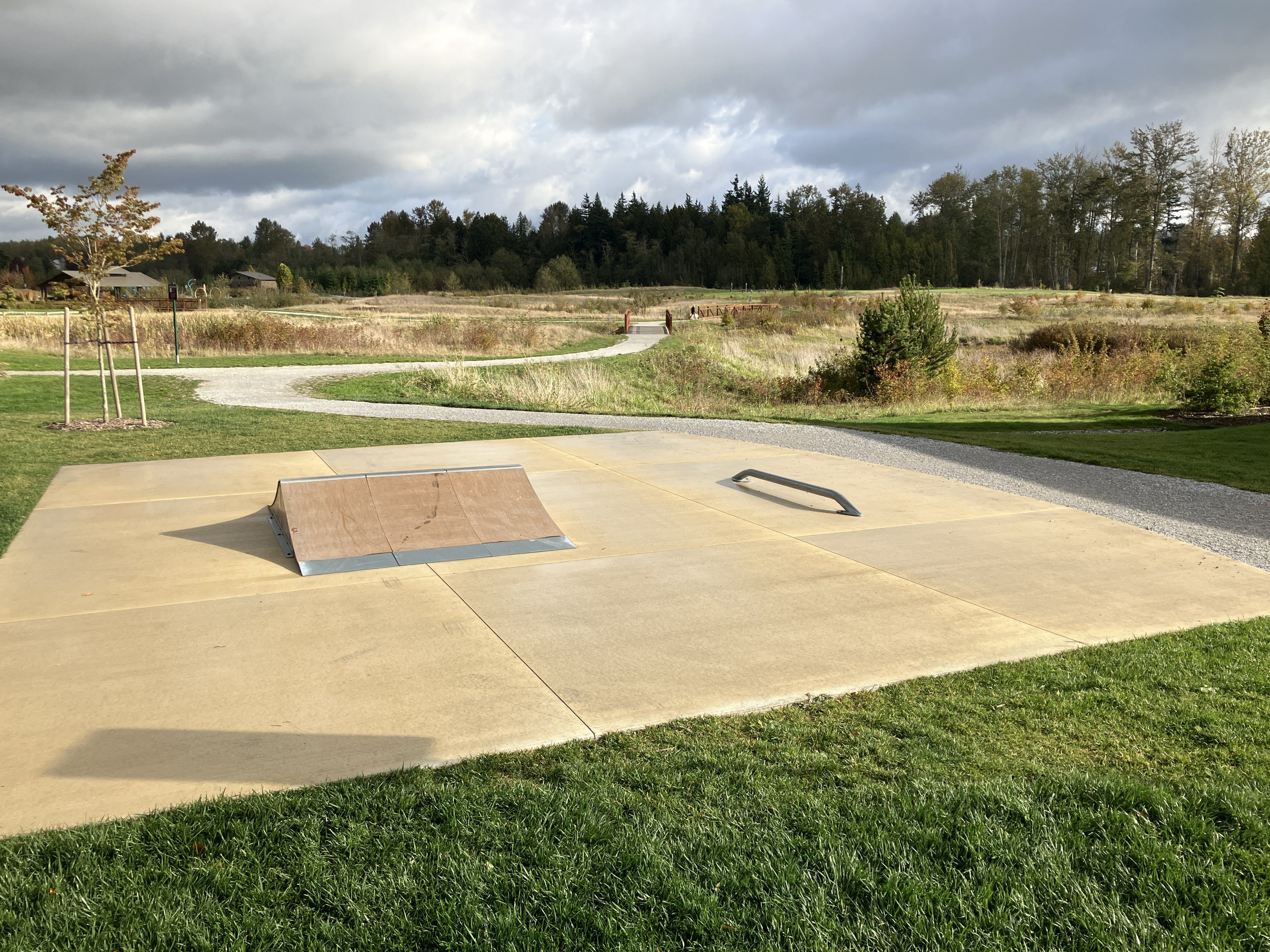A small skateboarding ramp and grind rail