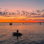 Man in a boat at sunset