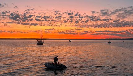 Man in a boat at sunset