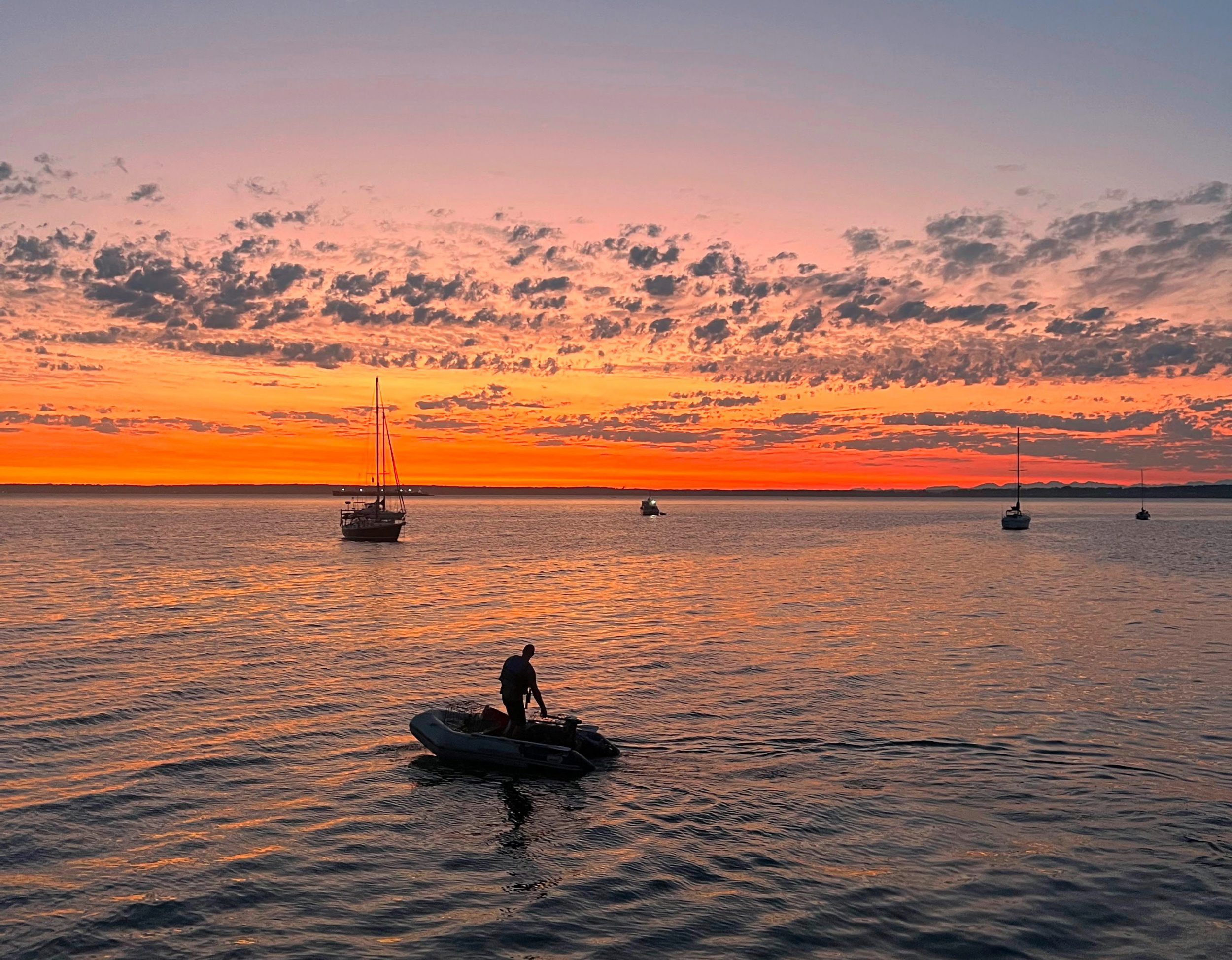 Man in a boat at sunset