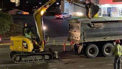 Heavy machinery removing fill into a dump truck