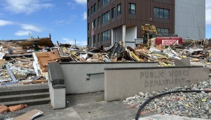 Building demolition debris from the old Pacific Street operation building in the foreground, with the new building, completed in 2023, in the background.