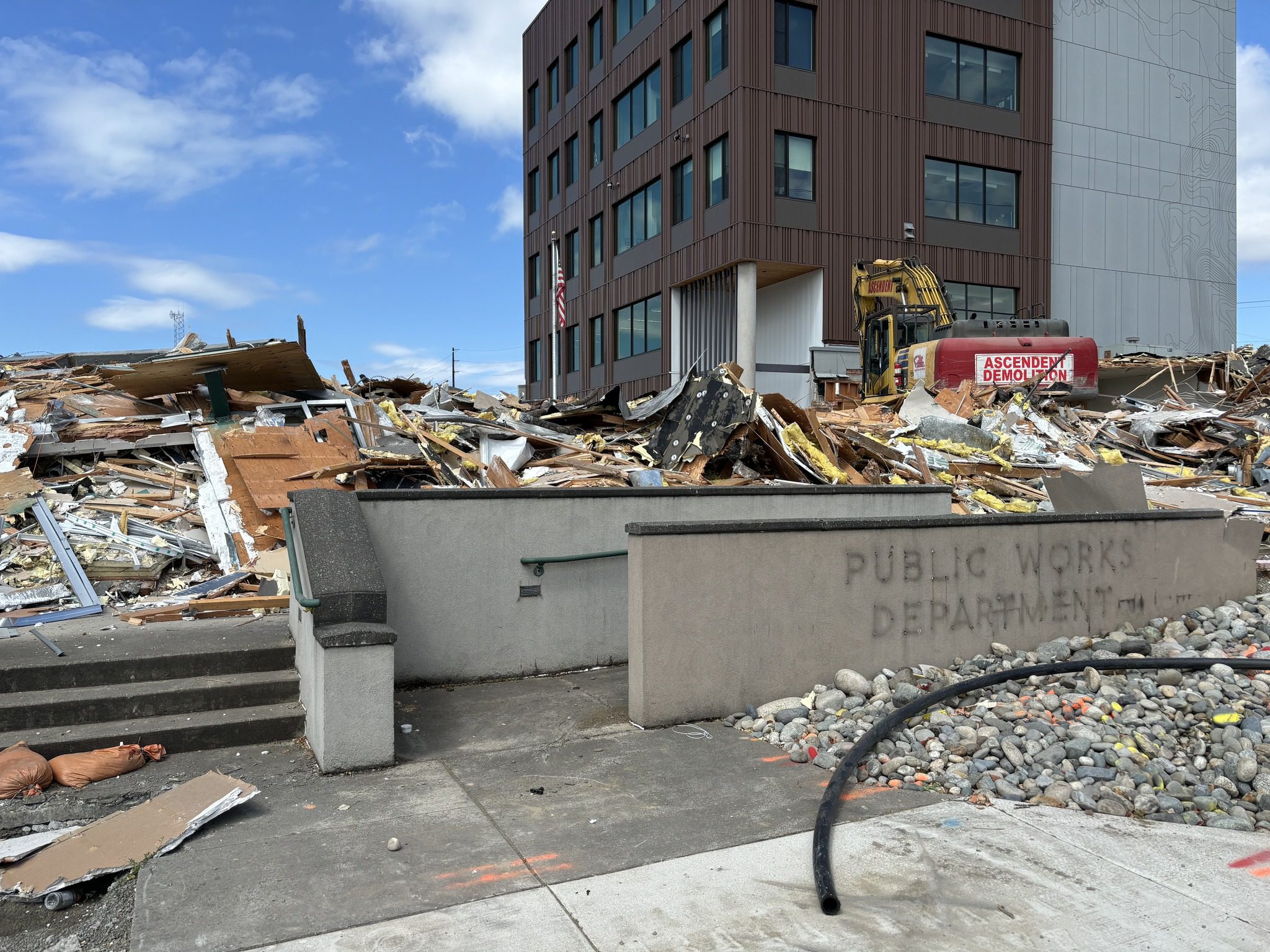 Building demolition debris from the old Pacific Street operation building in the foreground, with the new building, completed in 2023, in the background.