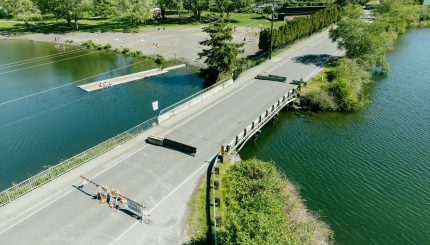 Aerial photo of bridge over waterway with barricades on the roadway indicating it is closed.