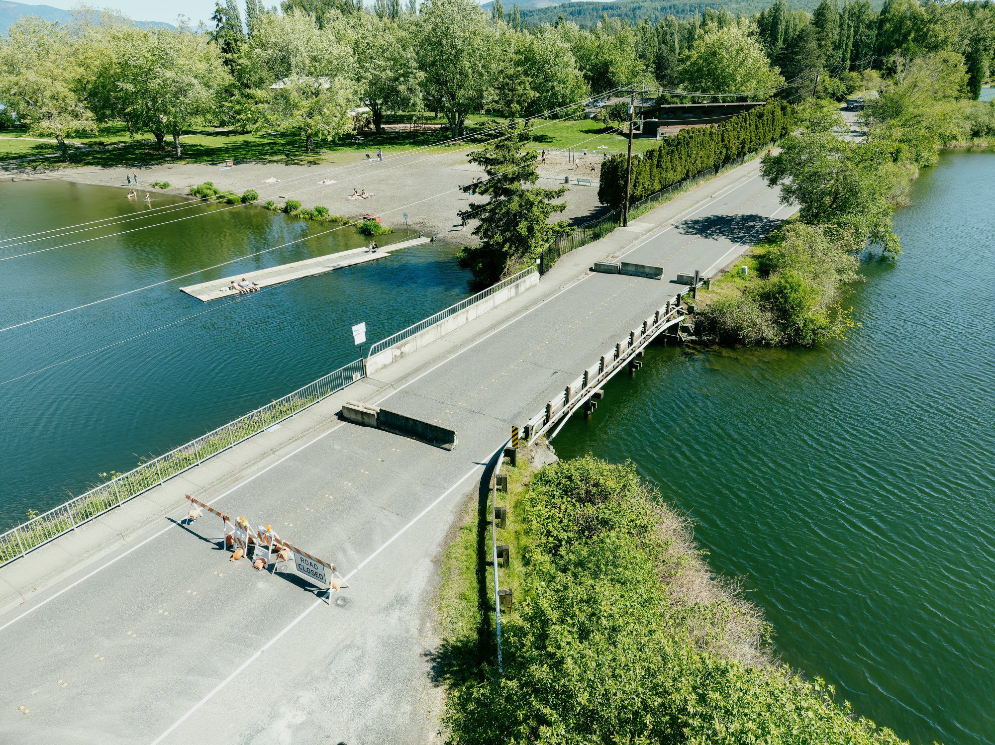 Aerial photo of bridge over waterway with barricades on the roadway indicating it is closed.