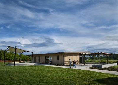 An enclosed park pavilion in a meadow
