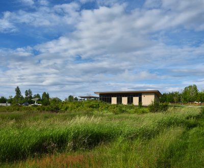 An enclosed park pavilion in a meadow