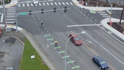 Aerial photo of bikes and cars at intersection