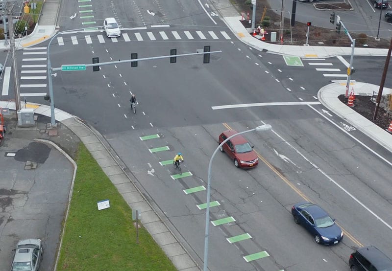 Aerial photo of bikes and cars at intersection