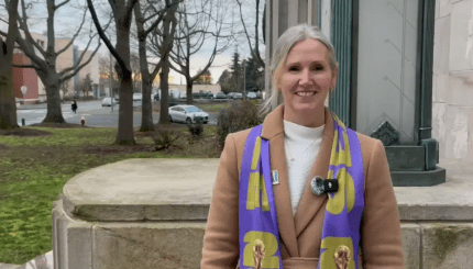 Mayor Kim Lund, wearing a Seattle FIFA World Cup scarf, is pictured on the steps oustide City Hall