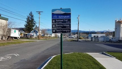 Sign with directions and mileage to help bicyclist navigate