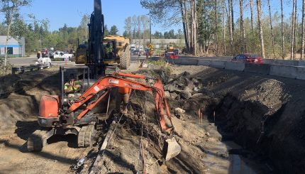 Excavator moving dirt to make new stream channel for Squalicum Creek near Squalicum Parkway.