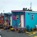 Several colorful tiny homes in a row at Unity Village