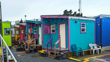 Several colorful tiny homes in a row at Unity Village