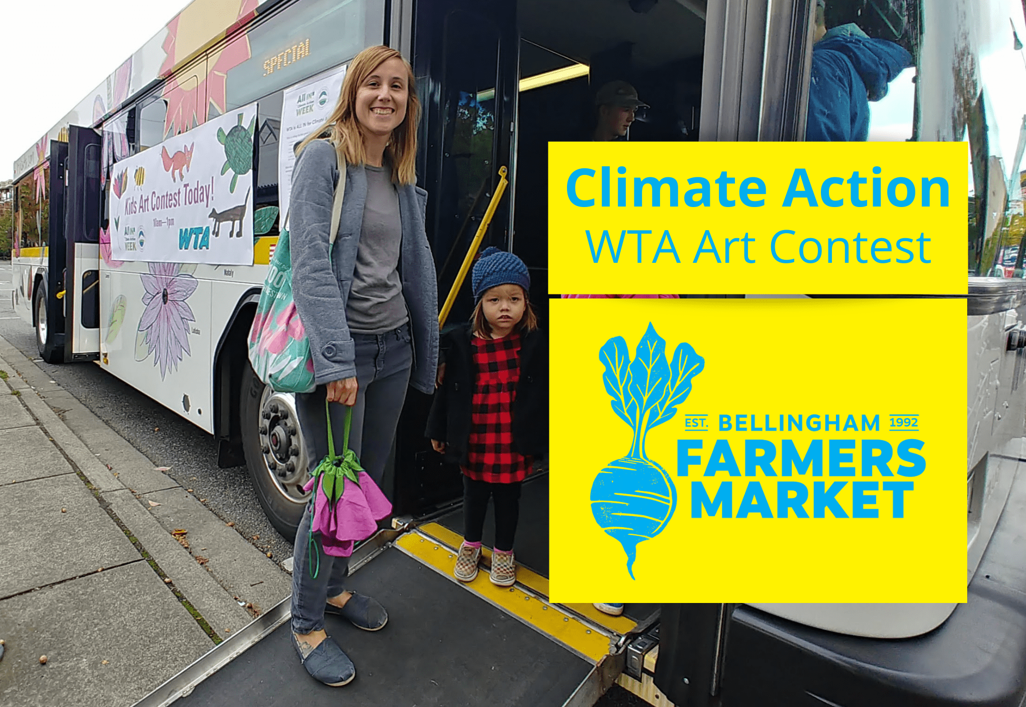 Adult and child standing in front of WTA bus with Bellingham Farmers Market logo and the words "Climate Action WTA Art Contest" in the foreground