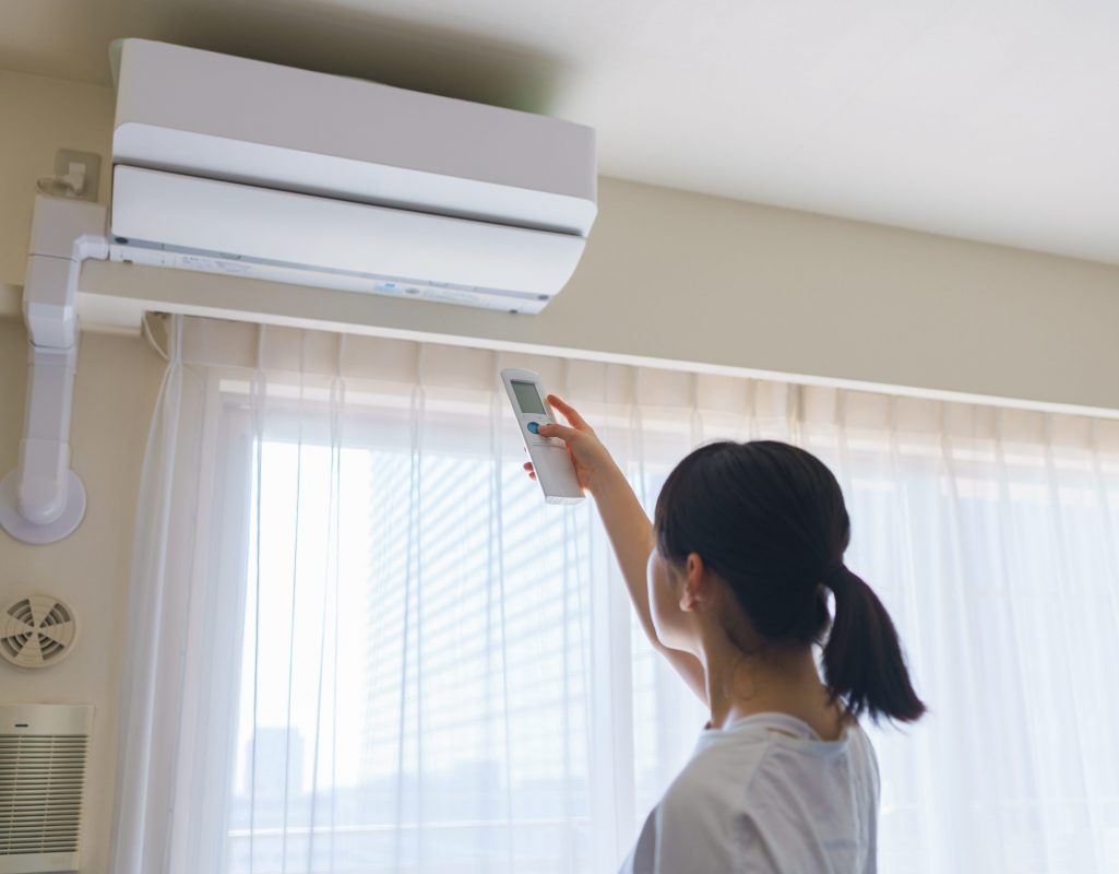 An individual adjusting the temperature of their electric space heating system. 