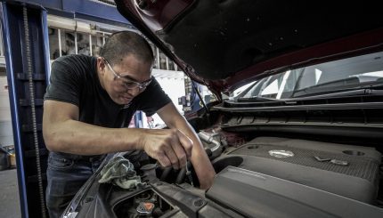 Person working on a car engine