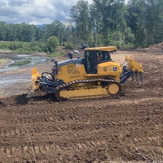 Heavy machinery grading dirt fill