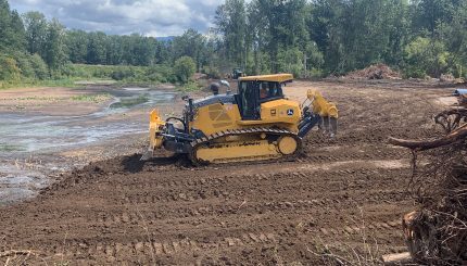 Heavy machinery grading dirt fill