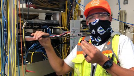 City employee holding up cables