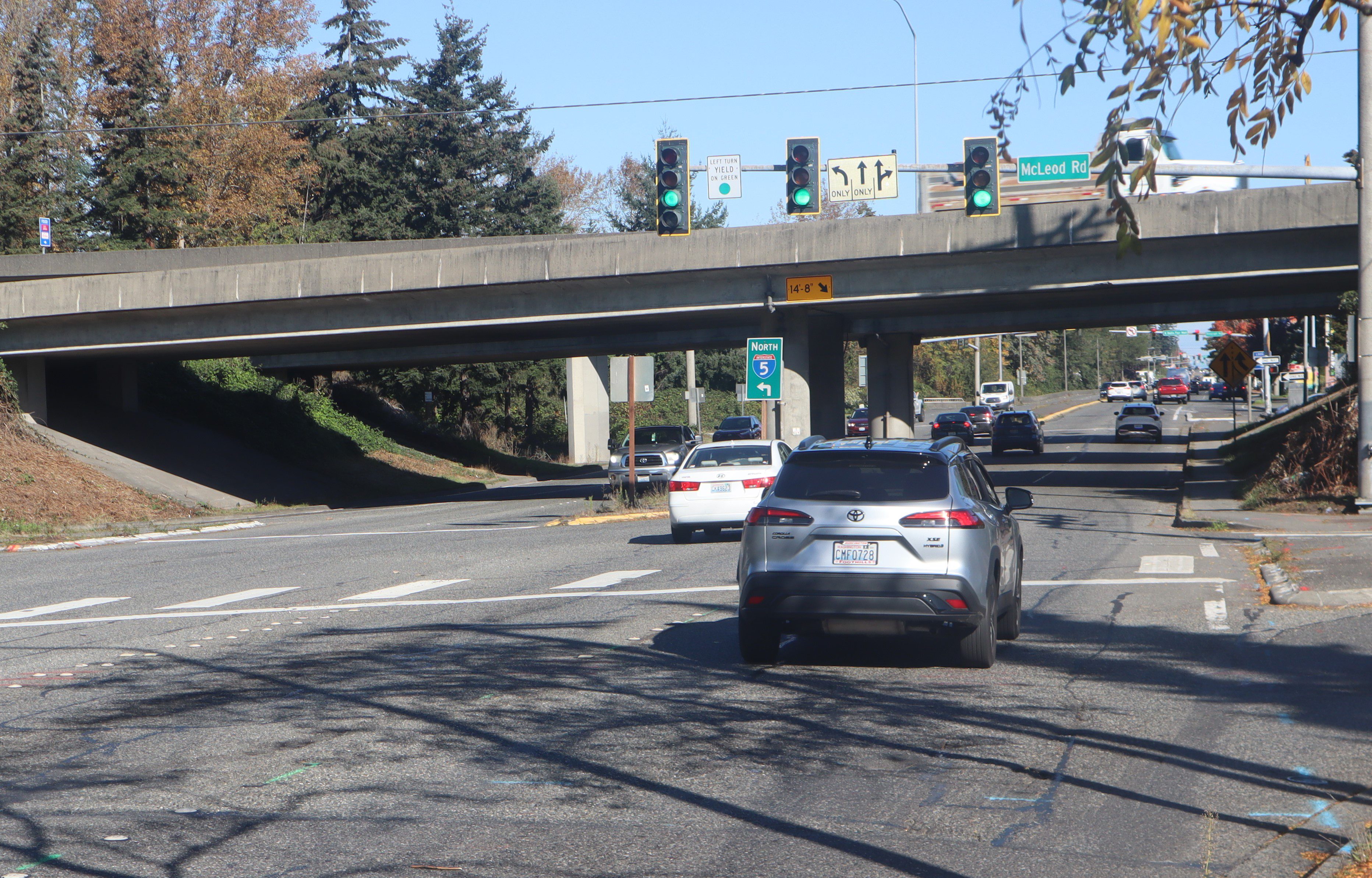 vehicles driving under overpass with Interstate 5 sign