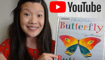 Screenshot of a YouTube video with a young girl holding a book with a butterfly on it